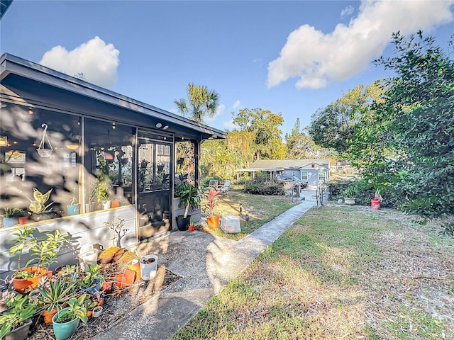 view of yard featuring a sunroom