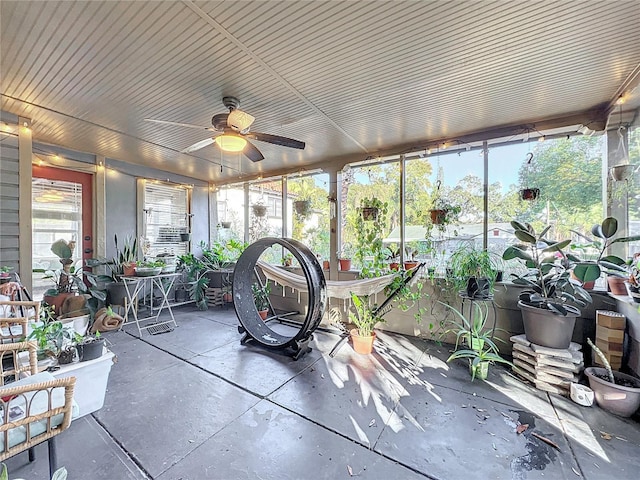 sunroom / solarium featuring ceiling fan