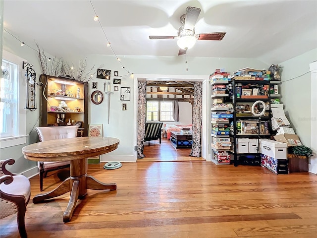 dining room featuring light wood-type flooring, vaulted ceiling, and ceiling fan