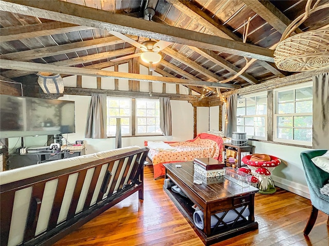 sunroom / solarium featuring vaulted ceiling with beams and wooden ceiling