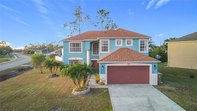 view of front of property featuring a front yard and a garage