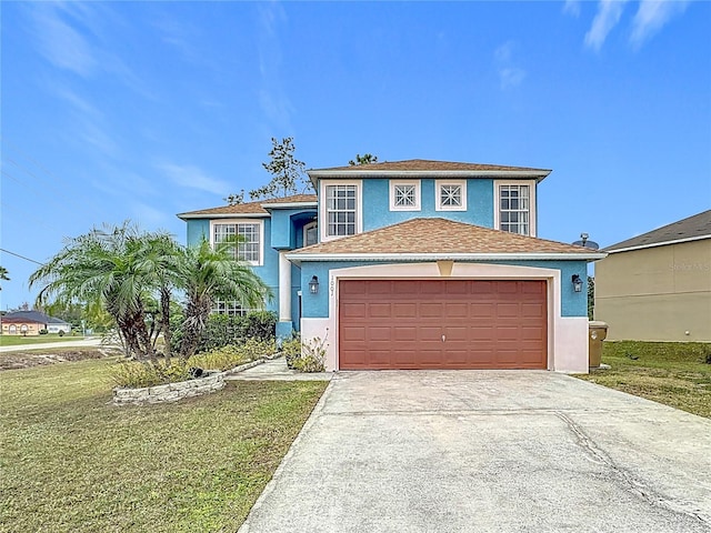 view of front of home with a front yard and a garage