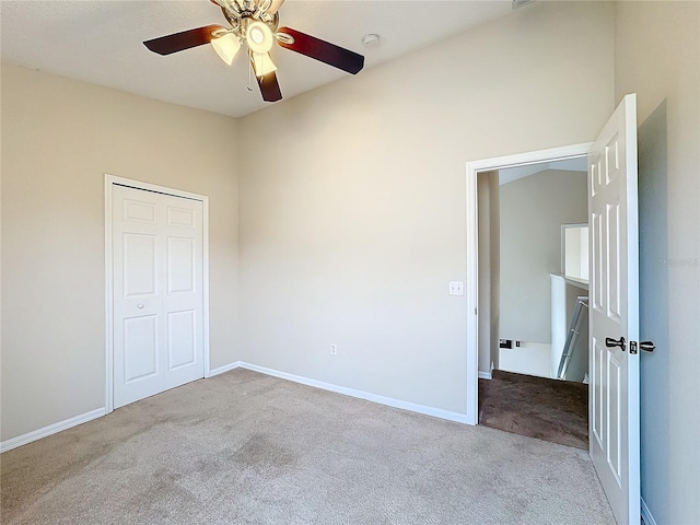 unfurnished bedroom with a closet, light colored carpet, and ceiling fan