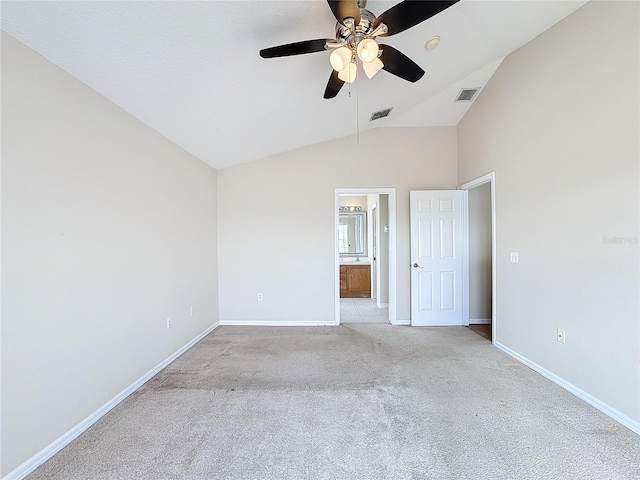 carpeted empty room featuring ceiling fan and lofted ceiling