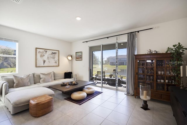 tiled living room featuring a healthy amount of sunlight