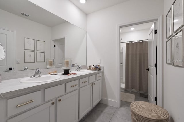 bathroom featuring tile patterned flooring and vanity