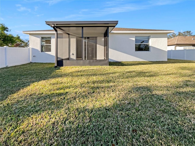 3105 46th St E, Palmetto, FL 34221 - rear view of property featuring a sunroom, stucco siding, and a fenced backyard