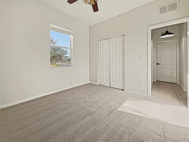 3105 46th St E, Palmetto, FL 34221 - unfurnished bedroom with carpet, a closet, and a ceiling fan
