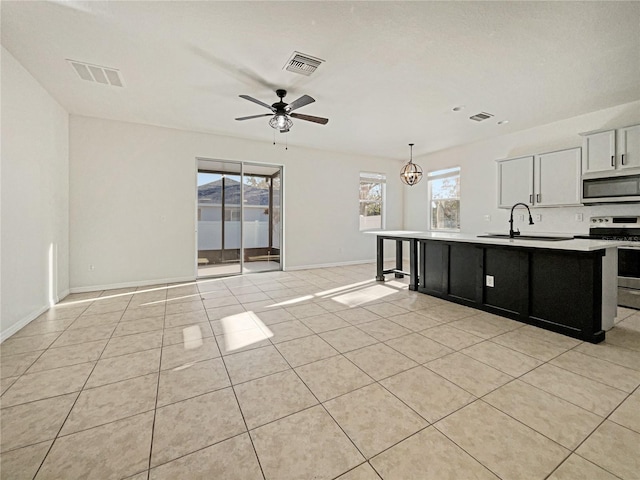 3105 46th St E, Palmetto, FL 34221 - kitchen featuring appliances with stainless steel finishes, a kitchen island with sink, open floor plan, and light tile patterned floors