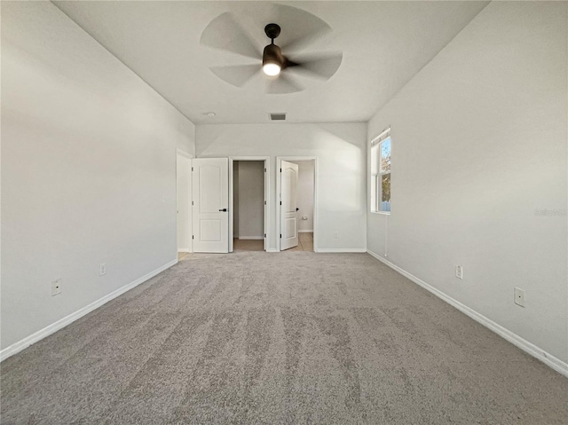 unfurnished room featuring ceiling fan and carpet