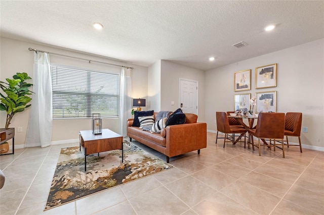 living room featuring light tile patterned floors and a textured ceiling