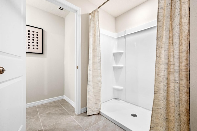 bathroom featuring tile patterned floors and a shower with shower curtain