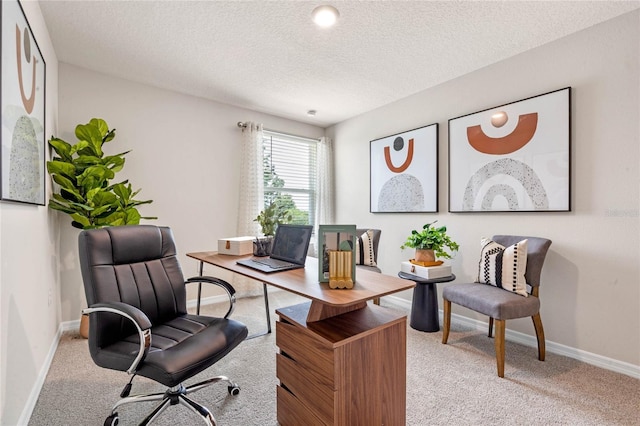 home office with light carpet and a textured ceiling