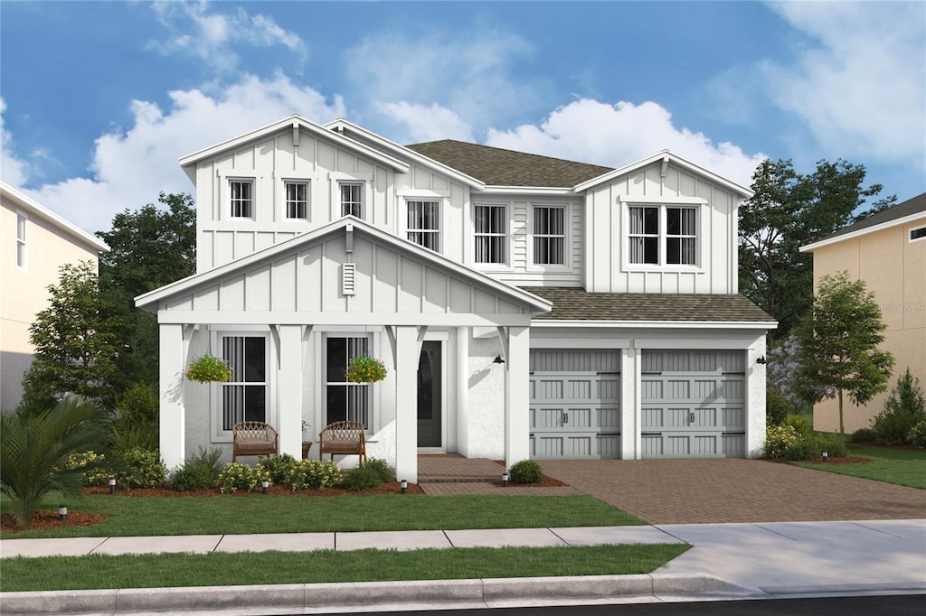 view of front of property featuring a front yard and a garage