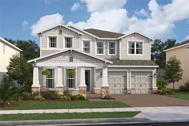 craftsman-style house featuring a garage and a front lawn