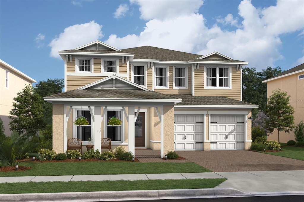 view of front of house featuring a front lawn and a garage