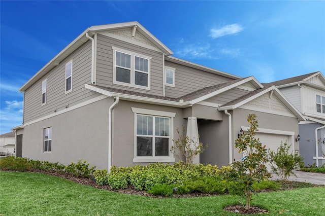 view of front of property with a front yard and a garage