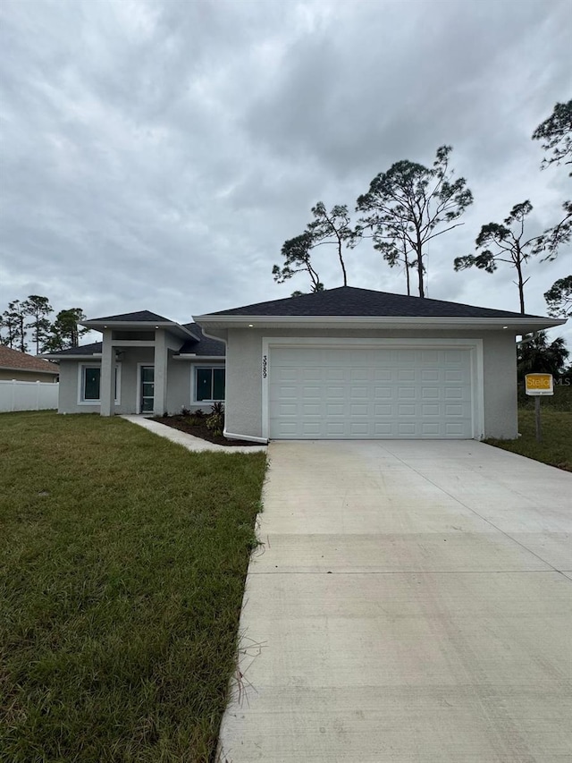 view of front of house with a front lawn and a garage