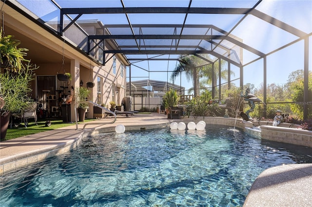 view of pool with pool water feature, a patio area, and a lanai