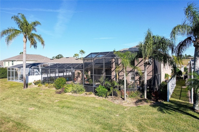 view of yard with glass enclosure