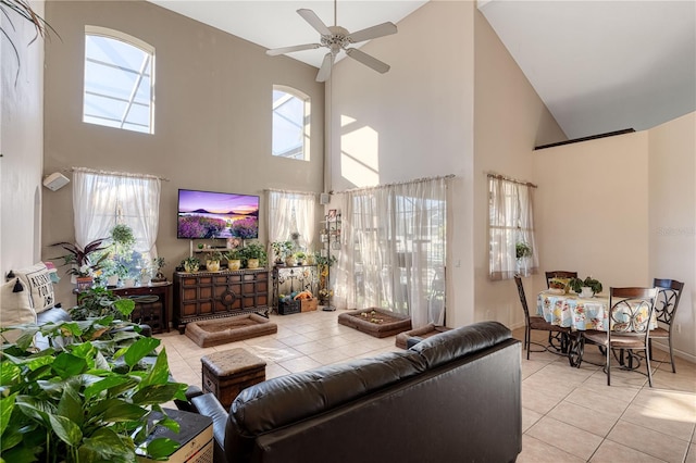 living room with light tile patterned floors, a towering ceiling, and ceiling fan