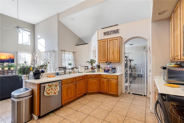 kitchen with a healthy amount of sunlight, ceiling fan, light tile patterned floors, and stainless steel dishwasher