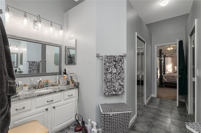 bathroom with a textured ceiling and vanity