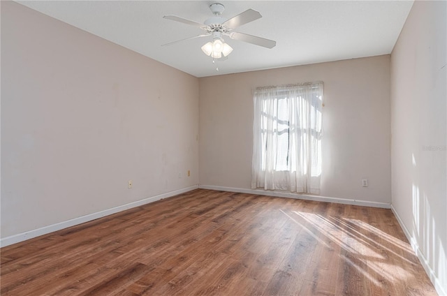 unfurnished room featuring ceiling fan and hardwood / wood-style floors