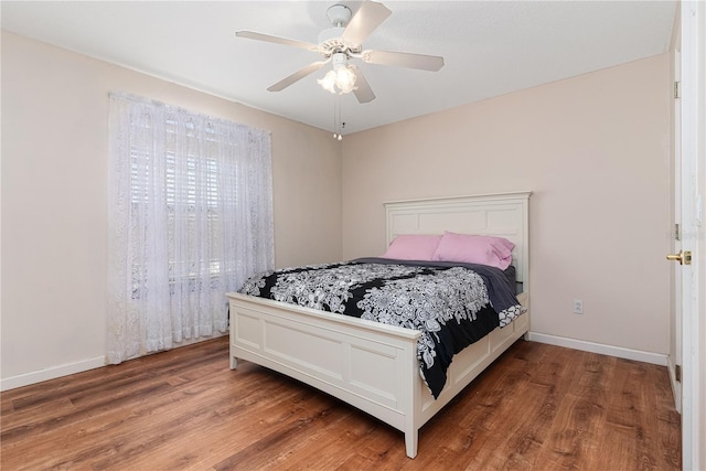 bedroom with hardwood / wood-style floors and ceiling fan