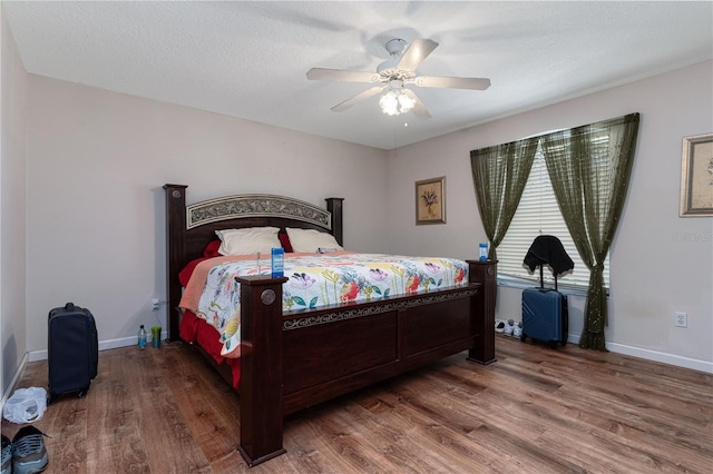 bedroom with ceiling fan and wood-type flooring