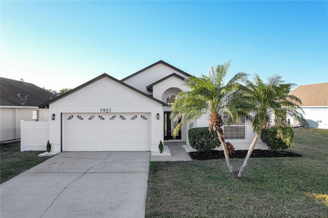 ranch-style home featuring a front yard and a garage