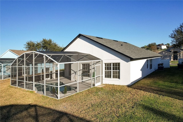 back of property with a lanai and a yard