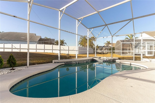 view of swimming pool with glass enclosure and a patio area