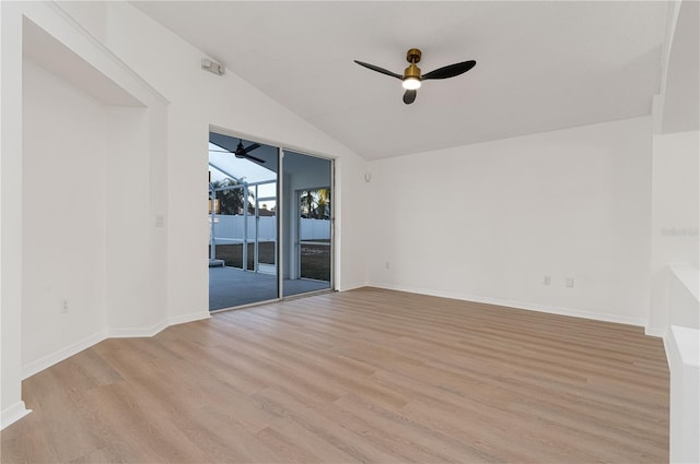 spare room featuring ceiling fan, vaulted ceiling, and light hardwood / wood-style flooring