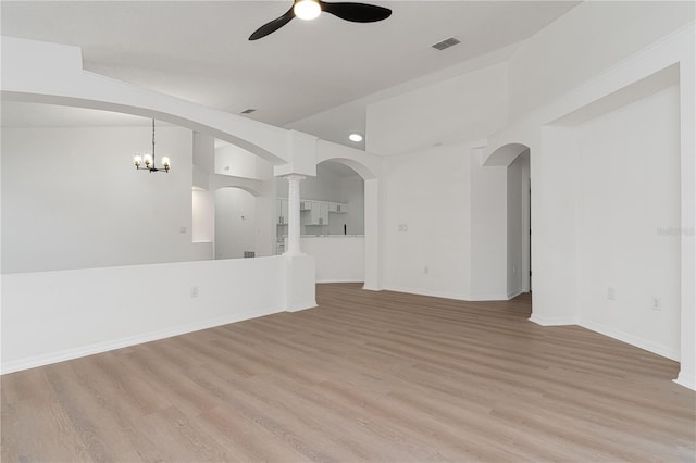 unfurnished living room featuring light hardwood / wood-style flooring and ceiling fan with notable chandelier