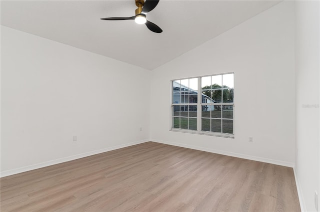 spare room featuring ceiling fan, vaulted ceiling, and light wood-type flooring