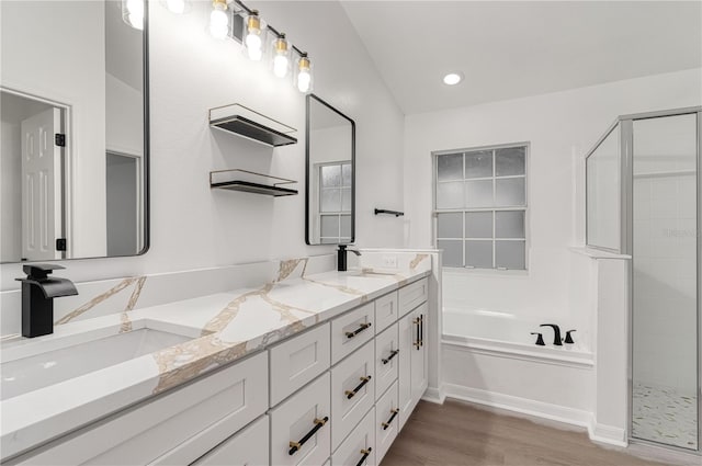 bathroom with hardwood / wood-style flooring, vanity, and separate shower and tub