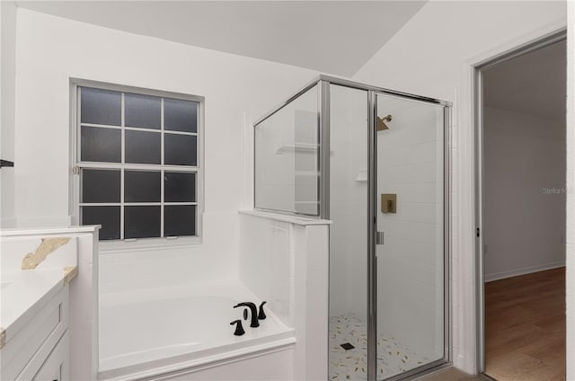 bathroom with separate shower and tub, hardwood / wood-style floors, and vanity