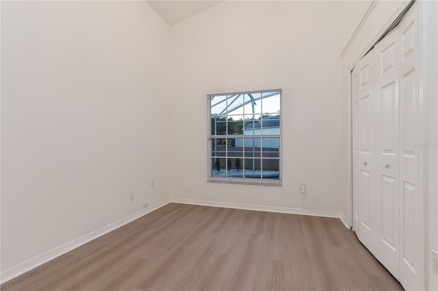 unfurnished bedroom with a closet and light hardwood / wood-style floors