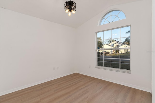 empty room featuring lofted ceiling and light wood-type flooring