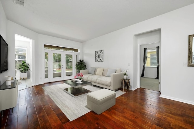 living room with dark hardwood / wood-style floors and french doors