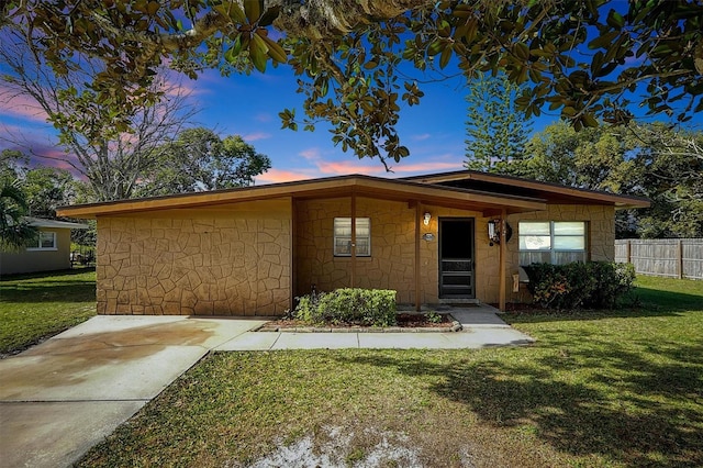 ranch-style house featuring a yard