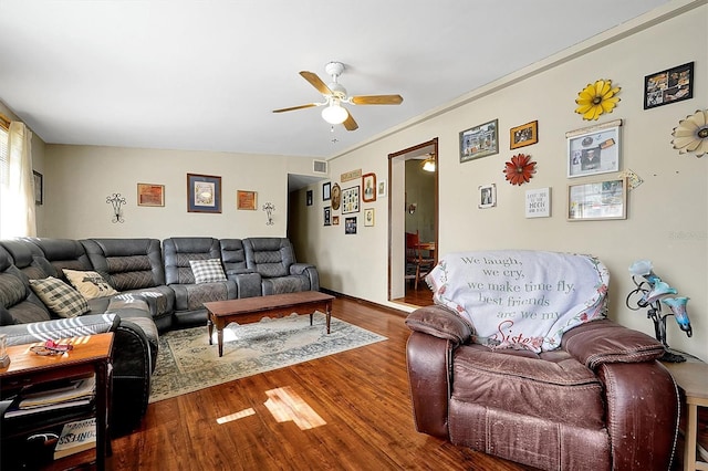 living room with wood-type flooring and ceiling fan