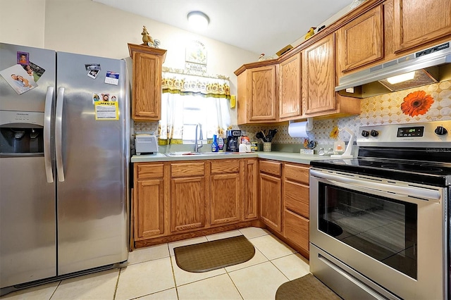 kitchen featuring backsplash, sink, light tile patterned floors, and stainless steel appliances