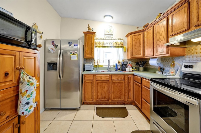 kitchen with decorative backsplash, sink, light tile patterned floors, and stainless steel appliances