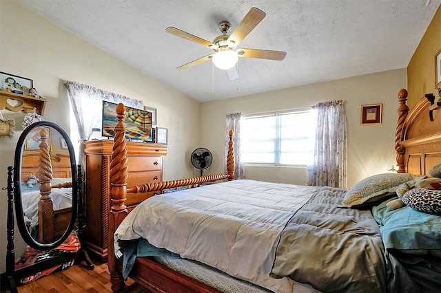 bedroom featuring hardwood / wood-style flooring, ceiling fan, and a textured ceiling