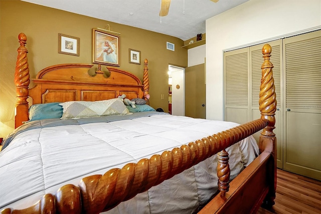 bedroom with wood-type flooring, a closet, and ceiling fan