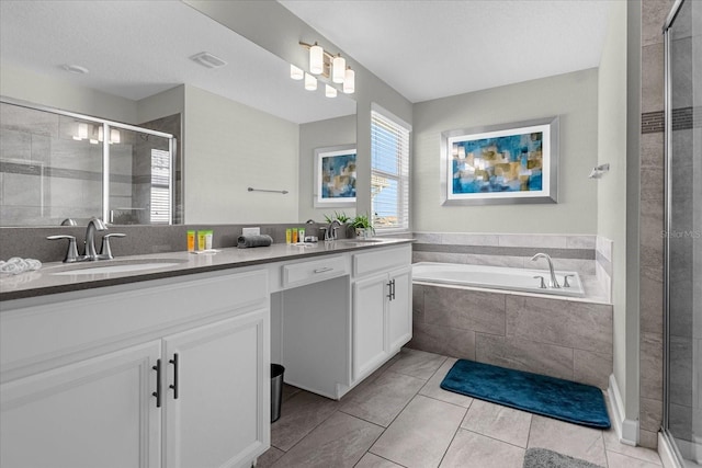 bathroom featuring tile patterned floors, vanity, and plus walk in shower