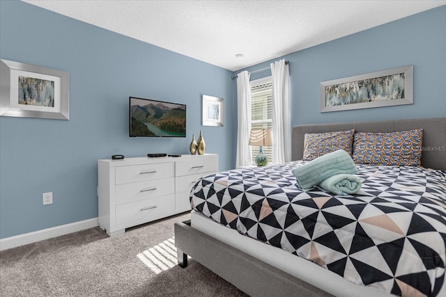 bedroom with a textured ceiling and carpet floors