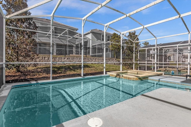 view of swimming pool with an in ground hot tub, a patio, and glass enclosure